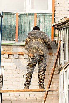 Workers walling the house with wall siding