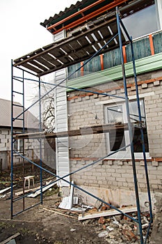 Workers walling the house with wall siding