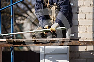 Workers walling the house with wall siding