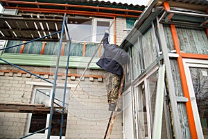 Workers walling the house with wall siding