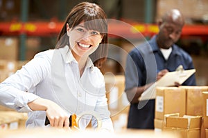 Workers In Warehouse Preparing Goods For Dispatch