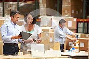 Workers In Warehouse Preparing Goods For Dispatch