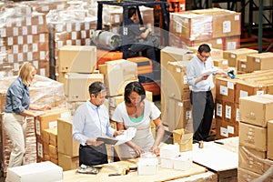 Workers In Warehouse Preparing Goods For Dispatch