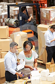 Workers In Warehouse Preparing Goods For Dispatch