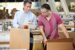 Workers In Warehouse Preparing Goods For Dispatch