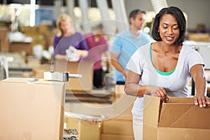 Workers In Warehouse Preparing Goods For Dispatch