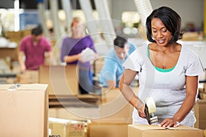 Workers In Warehouse Preparing Goods For Dispatch