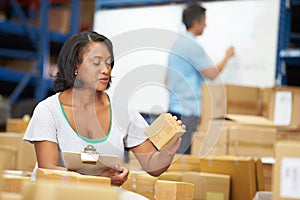 Workers In Warehouse Preparing Goods For Dispatch