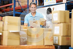 Workers In Warehouse Preparing Goods For Dispatch