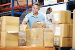 Workers In Warehouse Preparing Goods For Dispatch