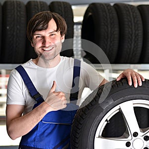 Workers in a warehouse with tyres for changing the car