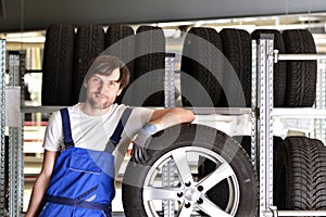 Workers in a warehouse with tyres for changing the car