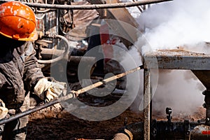 Workers are washing containers. From high pressure steam