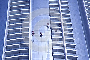 Workers washing the windows facae of a modern office building