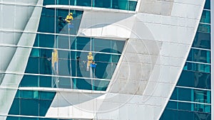 Workers washing windows of the modern skyscraper building timelapse