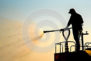 Workers on Water Truck are spraying water on the road