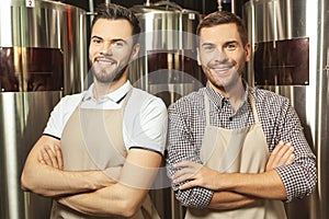 Workers wearing aprons with crossed hands