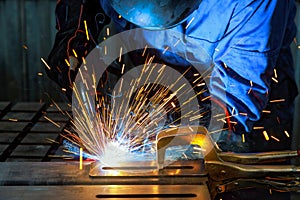 When workers weld using gas argon to steel, sparks are created that result in smoke within a factory