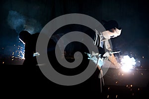 Workers with welding torches