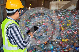 A workers work on recycle waste, Recycling Analyst looking at recycling waste To proceed to the next process