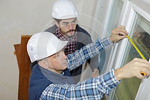 workers working with glass for windows at workshop