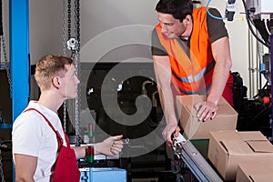 Workers working next to production line