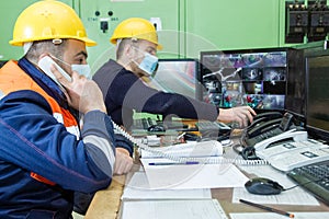 workers with yellow helmet and protective mask at work