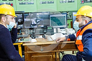 workers with yellow helmet and protective mask at work