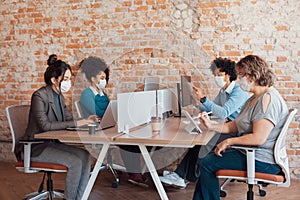 Workgroup working and typing on laptop