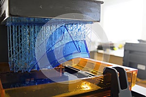 Working 3D printer. Electronic three dimensional printing machine in process