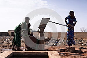 Working.African Ethnicity Young Women Carrying Natural Water for lack of water symbol photo