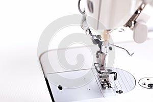 working area of a modern industrial sewing machine equipped with a narrow sewing foot for highspeed production of clothing