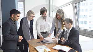 Working atmosphere in the office. employees to view documents in the workplace. group of business people discussing