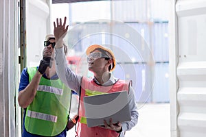 Working audit engineer team in shipping harbor port checking goods cargo container strength test for safety and security by