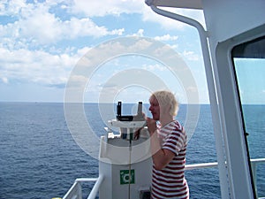 Working with azimuth device on merchant ship near coast photo