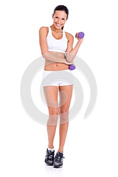 Working those biceps. Studio shot of an attractive young woman lifting dumbbells isolated on white.