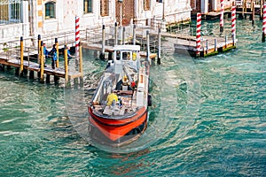 Working boat on Venetian canal in Venice, Italy