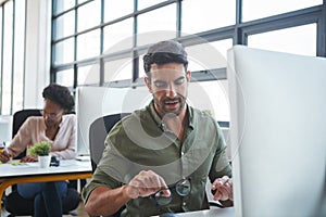 Working, business man and computer typing of a marketing employee in a office. Thinking, businessman and coworking