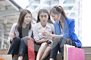 Working business women chating, talking and using mobile phone for shopping online