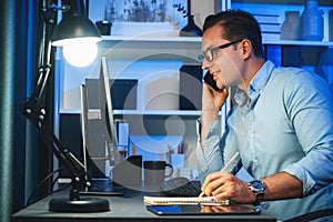 Working businessman calling phone with customer typing brief message. Sellable.