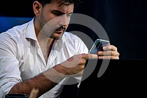 Working businessman using smartphone with customer or coworker. Sellable.