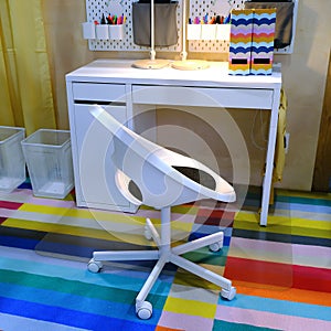 Working children`s table with a chair. Office supplies on the table