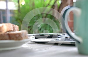 Working on the computer and cell phone while having breakfast