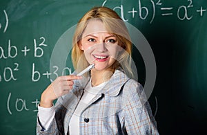 Working conditions which prospective teachers must consider. Woman smiling educator classroom chalkboard background