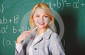 Working conditions which prospective teachers must consider. Woman smiling educator classroom chalkboard background