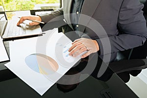 Working desktop of daily lifestyle for young businessman manager who is working in analysing data and information to make