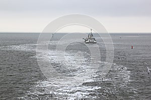 Working dredger in in Wadden Sea near Ameland island