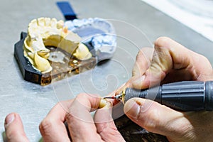 Working with a drill in a dental prosthesis