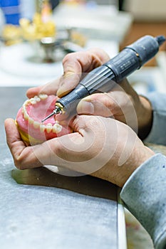 Working with a drill in a dental prosthesis