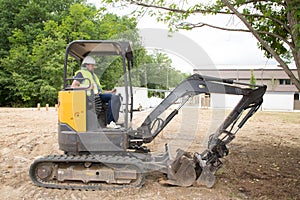Working excavator driver man in summer day